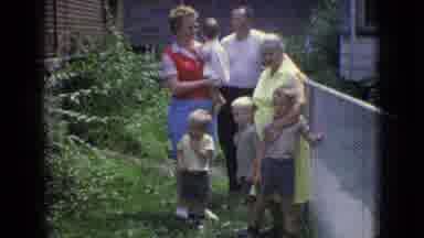 New Jersey USA (1965): A Family Is Posing By The Fence In Their Yard