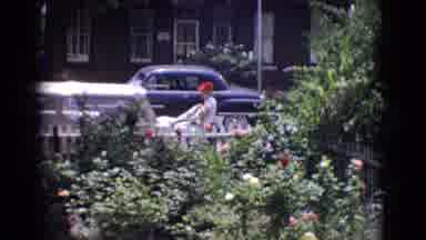 New Jersey USA (1965): There Is A Man Throwing A Bag On A Car