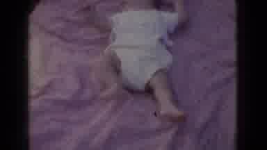 New Jersey USA (1965): A Baby Lays On Its Back On A Blanket Followed By A Fire