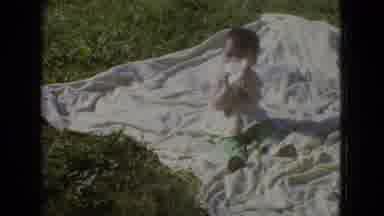 New Jersey USA (1965): Child Sitting Outside On A Blanket Eating A Snack