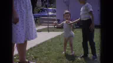 New Jersey USA (1965): Child Picks Up Toddler Outside