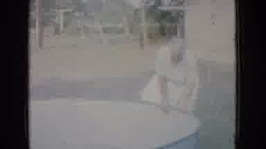 New Jersey USA (1965): Grandma Getting In Empty Pool In Her Apron