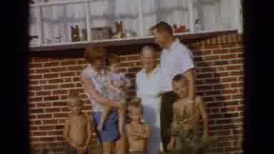 New Jersey USA (1965): A Family Standing Together In Front Of Their Home For A
