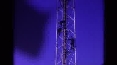 Athens Ohio USA (1966): Three Men Work On A Tower That Stretches Into A Blue Sky
