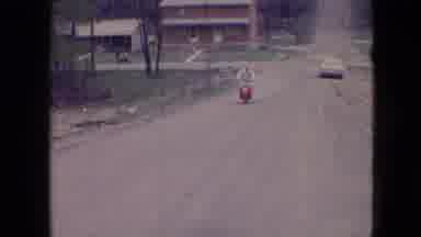 Athens Ohio USA (1966): Guy On Red Moped Driving Down Street
