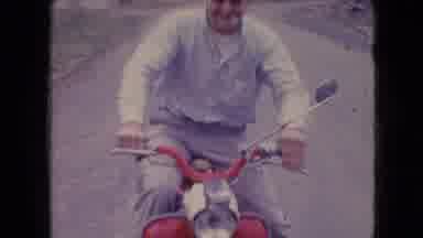 Athens Ohio USA (1966): Man Rides Motorcycle And Child Swinging