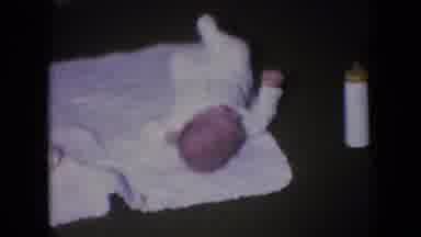 Athens Ohio USA (1966): Baby Laying On Blanket Moving Around Hand Takes Vessel