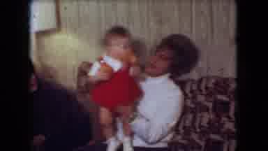 Athens Ohio USA (1966): Woman Carrying Baby In A Children Party From The Seventies