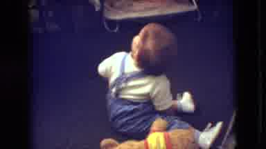 Athens Ohio USA (1966): There Is A Young Baby Sitting On The Floor Waving Around