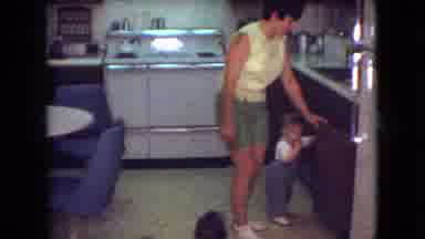 Athens Ohio USA (1966): A Lady In The Kitchen Looking Through The Cupboards While