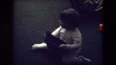 Athens Ohio USA (1966): A Baby Putting On A Hat