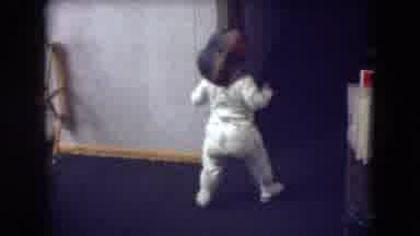 Athens Ohio USA (1966): Young Child In Pajamas And A Hat Walking With A Large