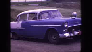 New Jersey USA (1966): Classic Blue Car Reverses Down A Grassy Hill