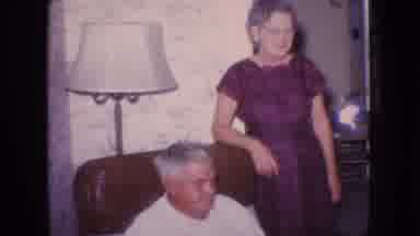 New Jersey USA (1966): Older Couple Lounges In Living Room While Man Sits On Arm