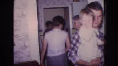 New Jersey USA (1966): Man Holding A Baby At A Family Gathering In Someone's Home