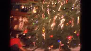 New Jersey USA (1966): Kid Opening Christmas Gifts Kept Under Big, Bright And