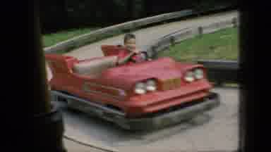 New Jersey USA (1966): Antique Toy Cars Being Driven Around An Amusement Park