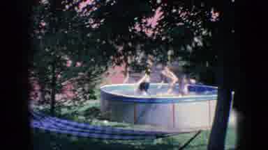 New Jersey USA (1966): Three Boys Roughhousing In The Backyard Above Ground
