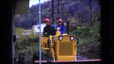 Ohio USA (1966): Two People Riding Yellow Tractor