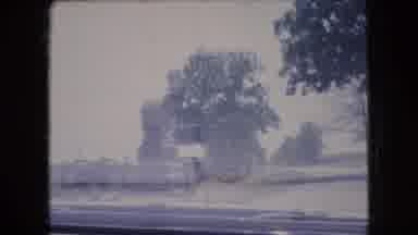Ohio USA (1966): A Car Driving Down The Street Of A Small Town