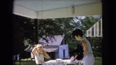 Ohio USA (1966): Mother Serving Lunch To Her Daughter In Her Backyard