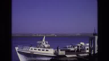 PORTUGAL-1972: Ferry Docked at Waterfront with Classic Car and Passengers