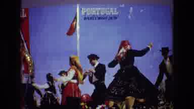 PORTUGAL-1972: Traditional Folk Dance Performance with 'Portugal Welcomes You' Banner