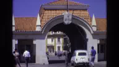 Portugal (1972): People Walking Near White Gateway
