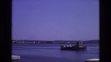 PORTUGAL-1972: Loaded Ferry Floats Across The Bay; People Walk Through An Open Archway