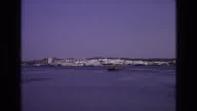 PORTUGAL-1972: A Boat Sailing Towards A City Of White Buildings