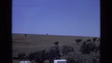 Portugal (1972): An Idle Car Sits On A Street Next To An Open Field