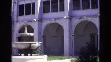 PORTUGAL-1972: Fountain In The Foreground Of An Historical Building With Arched Walkways