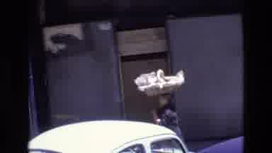 Portugal (1972): Woman Carrying Basket On Head Walking Down A Street Of A City
