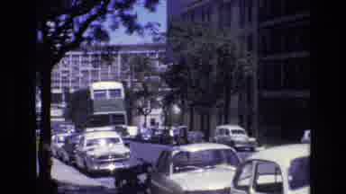 Portugal (1972): Double Decker Bus Traveling Down A City Street Lined With Cars