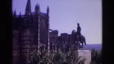 Portugal (1972): A Statue Stands In Front Of A Multi-Story Gothic-Style Building