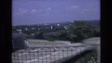 Spain (1972): Car Driving Alongside A Road With Green Land