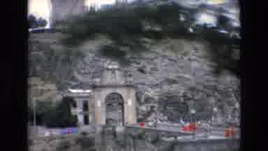 Spain (1972): Bridge Red Shirts Concrete Buildings Cars People