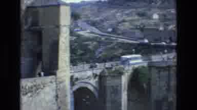 Spain (1972): Buildings And People Walking Through A City Built Of Bricks And