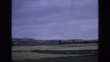 Spain (1972): Green Plateaus Against A Bright Blue Sky While Driving Through The