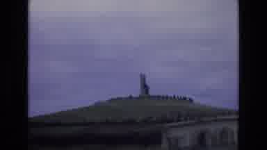 Spain (1972): A Structure Stands On Top Of A Grassy Hilltop Surrounded By A Circle
