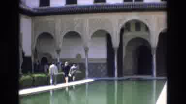 Spain (1972): People Walk Along Pool That Is Before Ornate Eaves Before Cutting To