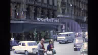 Spain-1972: People Walking Near CorteFiel Building With Classic Cars and White Van