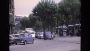 Spain (1972): Blue Car Turning Corner On Busy Street