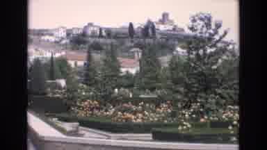 Spain (1972): People Seen Walking On Large Path In Public Garden