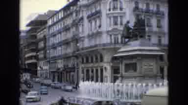 Spain (1972): A Water Fountain Stands In The Middle Of A Traffic Circle In An