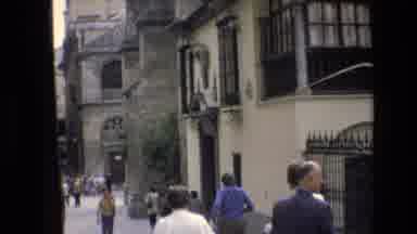 Spain (1972): People Walking Around Building