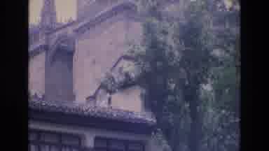 Spain (1972): The Side Of A Building With Spanish Tile Roof Slashed Windows And