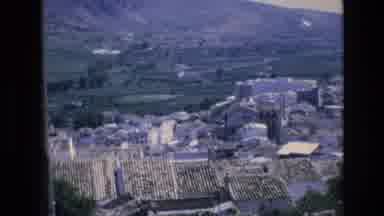 Spain (1972): City Rooftops And Fields In Front Of Mountain