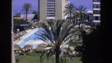 Spain (1972): Tall Building Swimming Pool Trees People