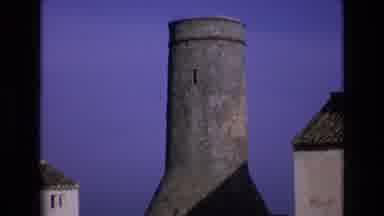 Spain (1972): Stone Tower Between Two Buildings